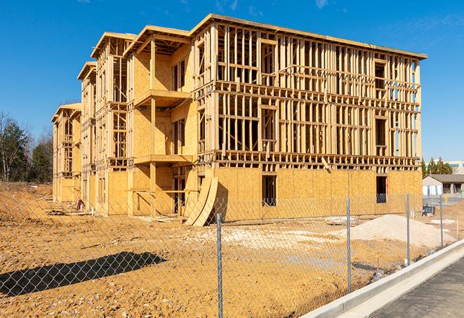 a close-up of temporary chain link fences enclosing a job site, signaling progress in the project's development in El Granada